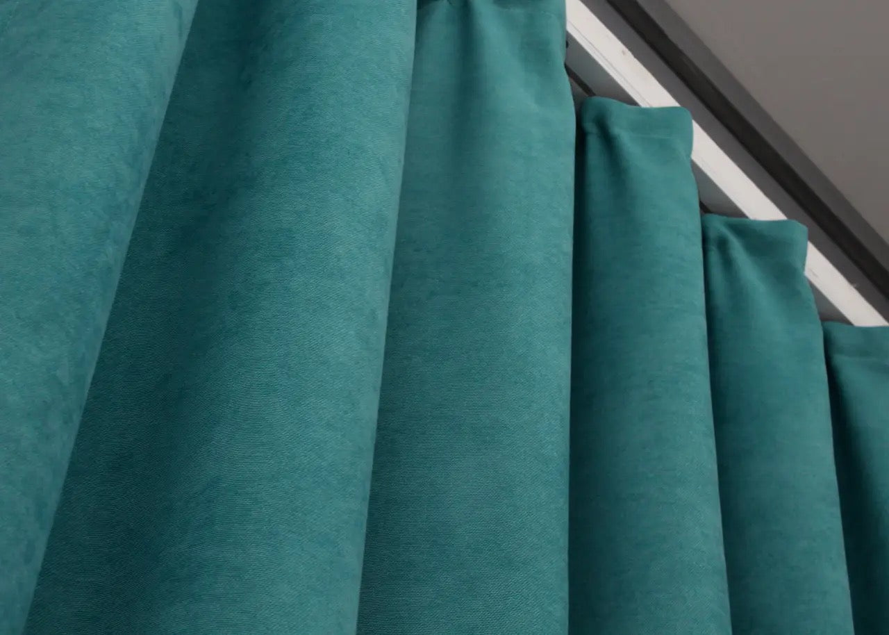 Modern luxury teal curtains with a plush velvet finish, elevating home décor.
