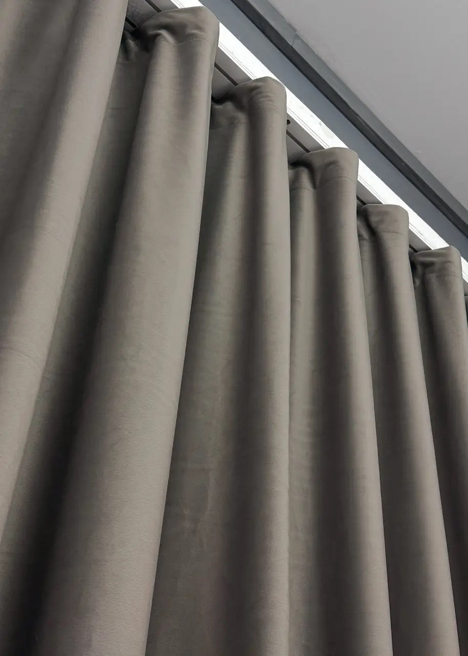 Muted mocha grey velvet curtains with soft plush material, providing a refined and timeless look for stylish window treatments.
