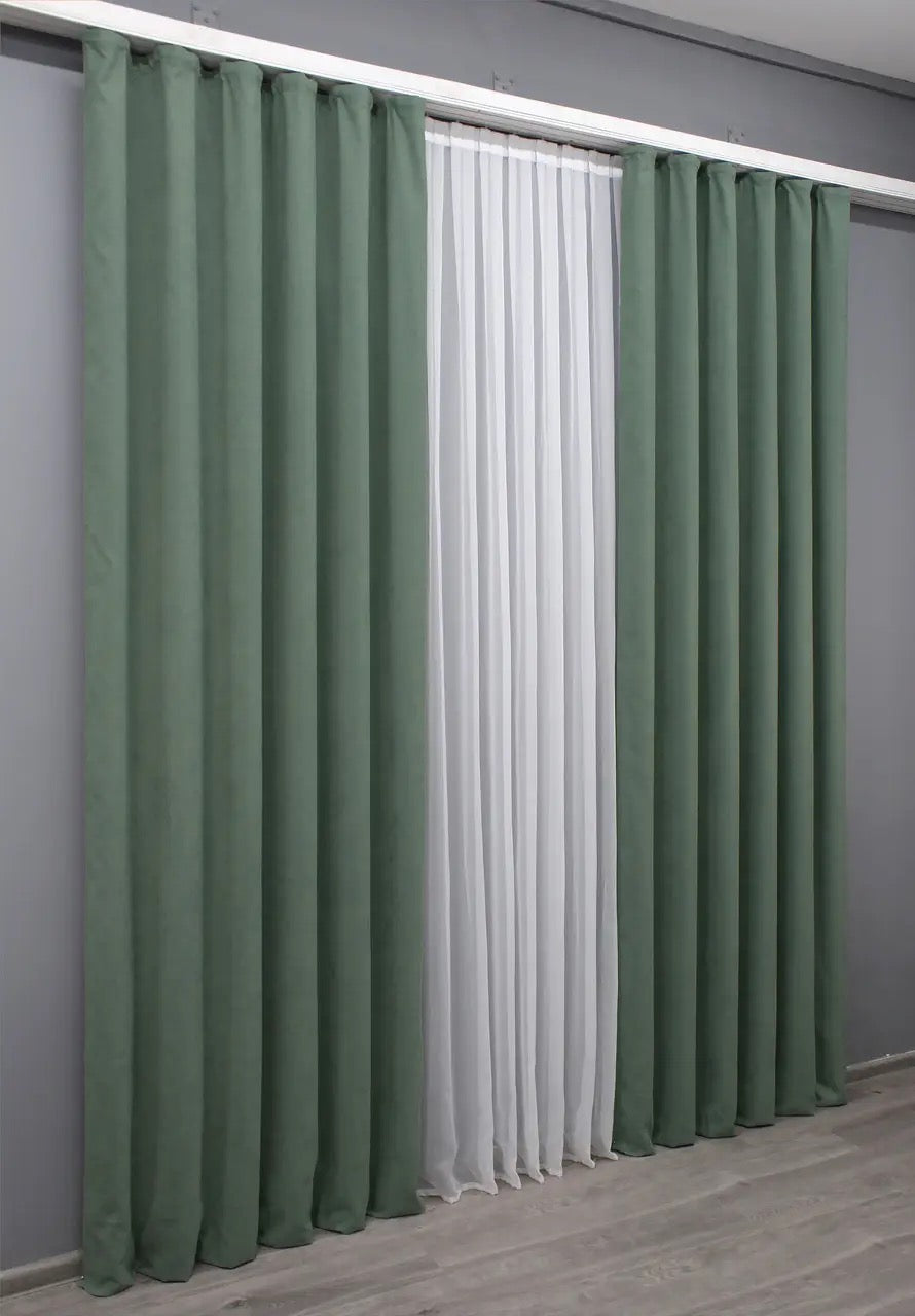 Olive green velvet drapes, offering a smooth finish and timeless sophistication for home decor.
