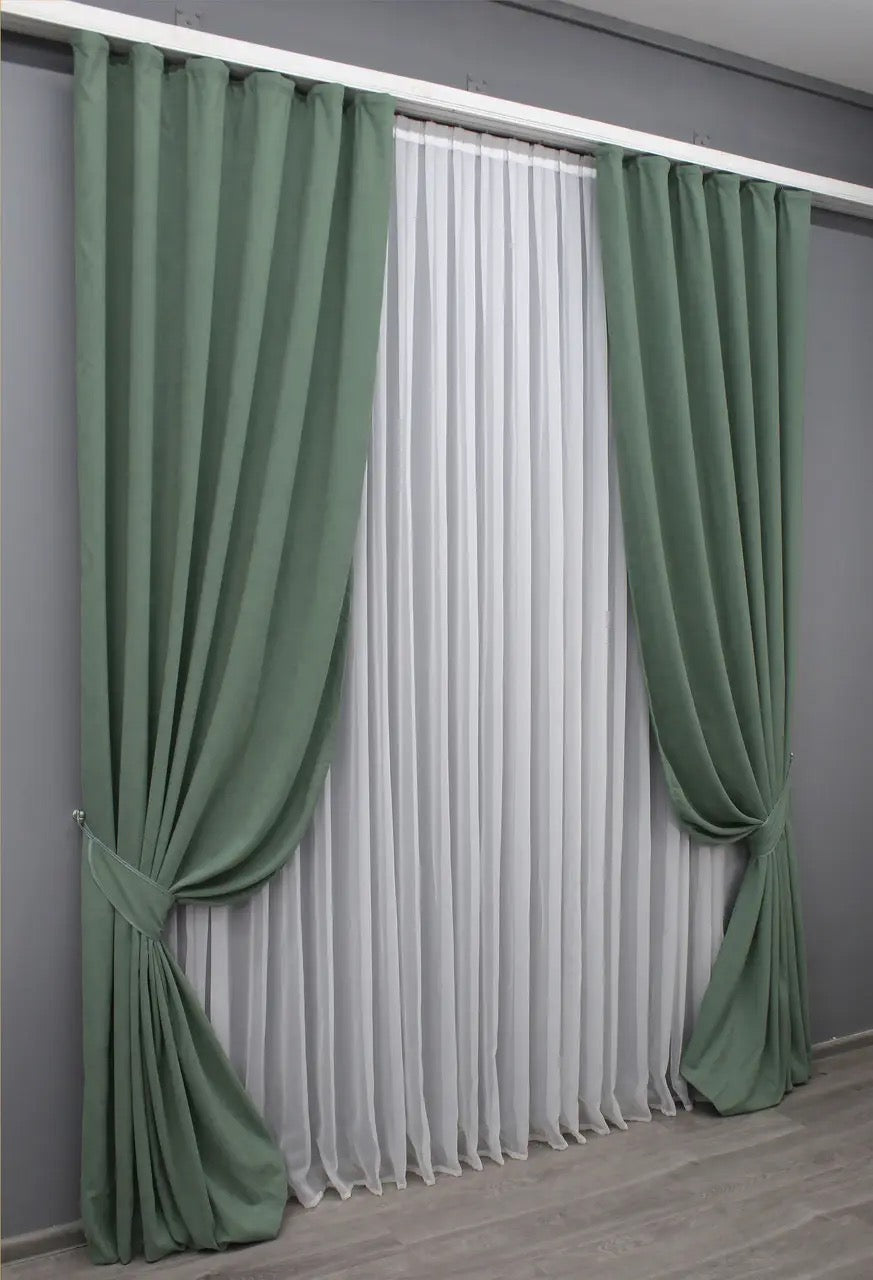 Olive green velvet drapes, offering a smooth finish and timeless sophistication for home decor.
