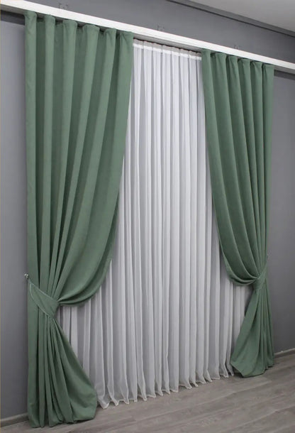 Olive green velvet drapes, offering a smooth finish and timeless sophistication for home decor.
