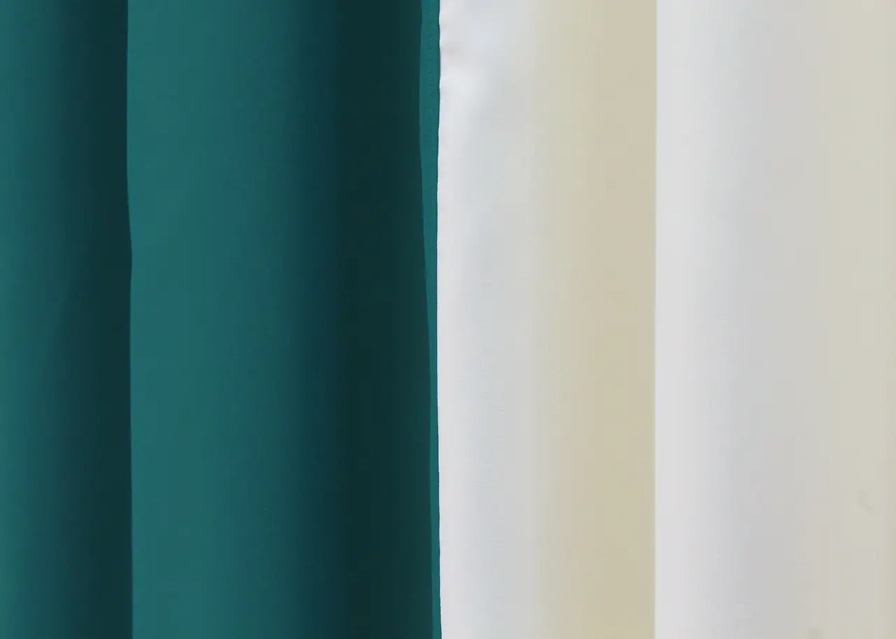 Sophisticated emerald and cream blackout curtains offering a harmonious two-tone design for a modern, balanced look in your space.
