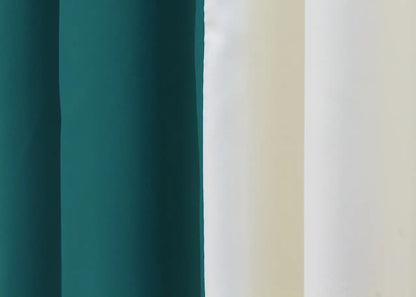 Sophisticated emerald and cream blackout curtains offering a harmonious two-tone design for a modern, balanced look in your space.
