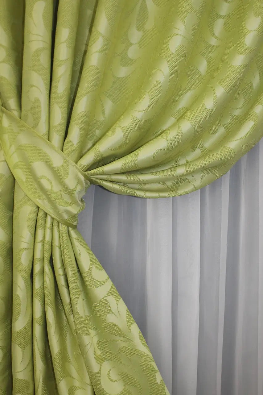 Premium olive green Venzel drapes with a decorative scrollwork pattern, bringing a luxurious touch to home decor.
