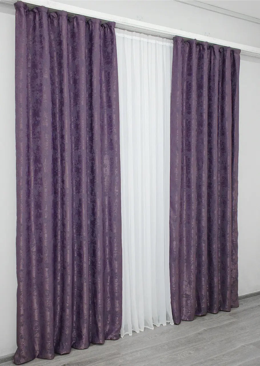 Luxurious purple curtains with an intricate woven jacquard pattern, adding depth and style to window décor.
