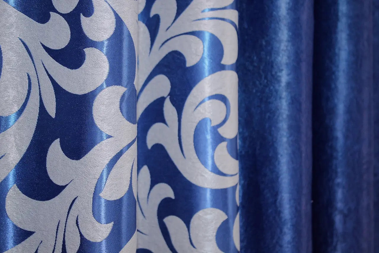 Premium dual-tone blue and silver combined blackout curtains with a smooth finish and stylish tie-backs.
