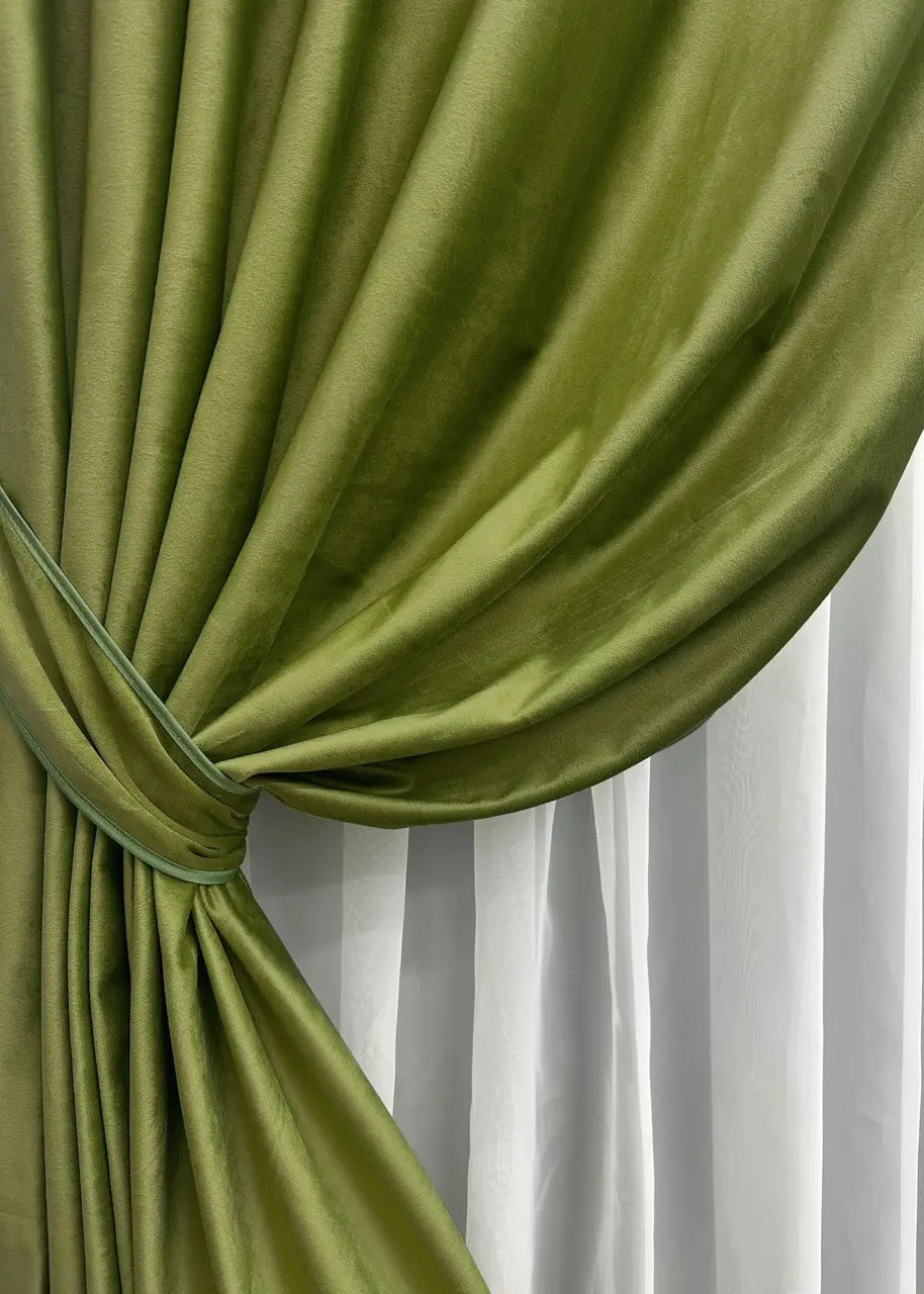 Soft-touch olive velvet curtains draped in a classic home décor setting.
