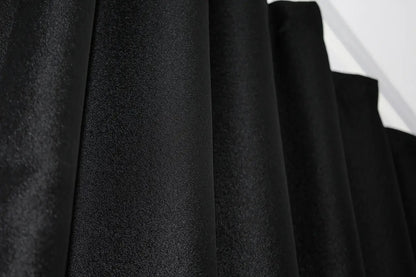 Ultra-soft black-grey linen drapes with gold pattern, adding depth and sophistication to any room.
