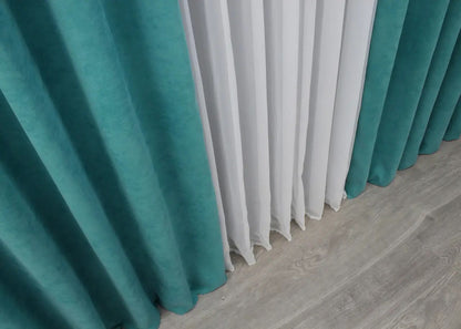 Refined deep aqua microvelvet curtains, balancing functionality and stylish appeal.
