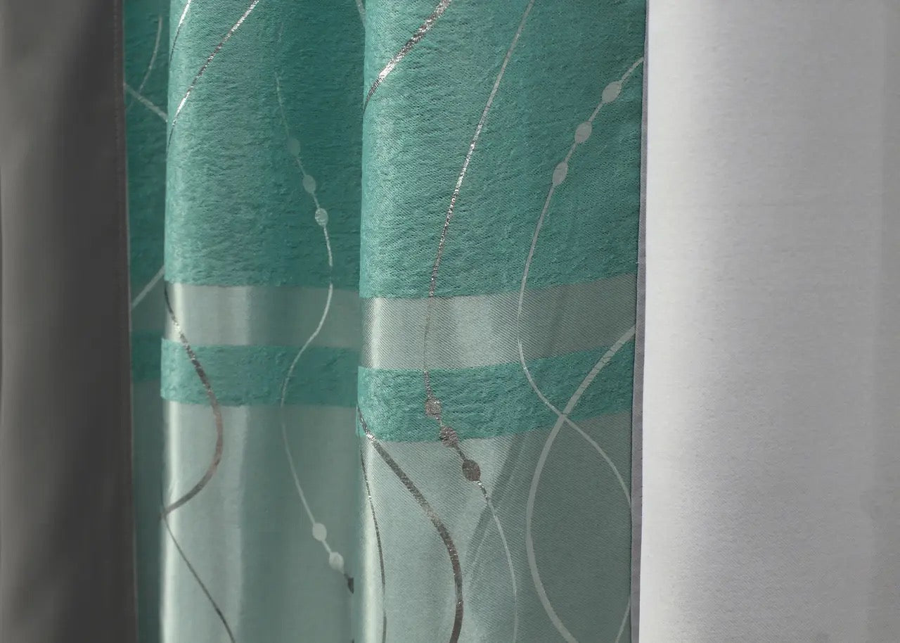 Refined graphite & turquoise-grey curtains for a modern living room, combining elegance with practicality.
