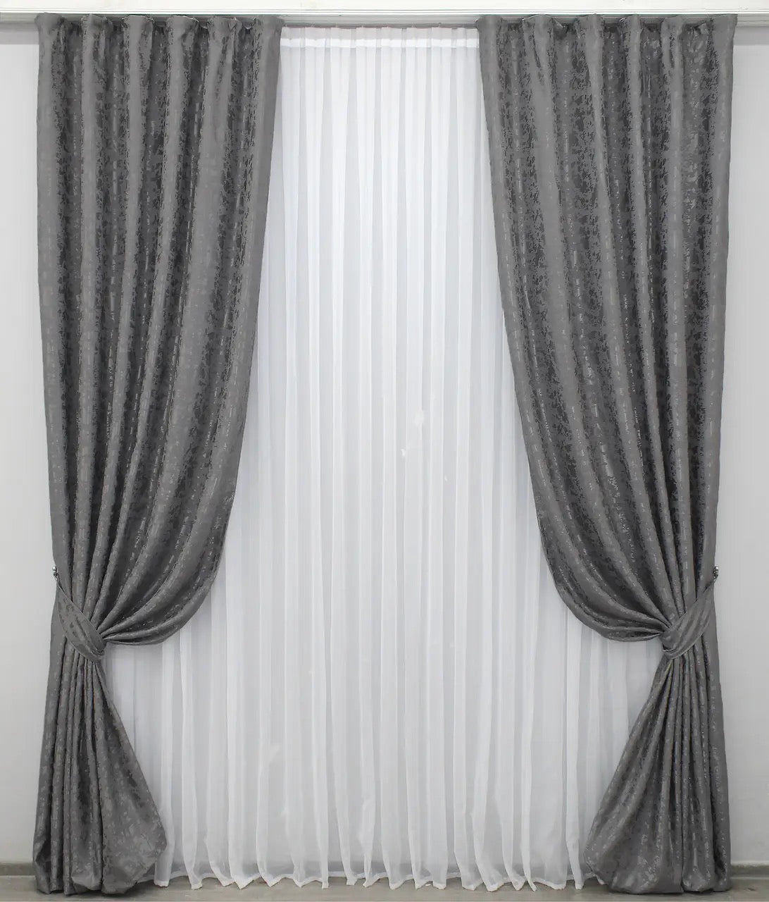 Soft grey linen drapes with a delicate marble texture, perfect for stylish and contemporary home decor.
