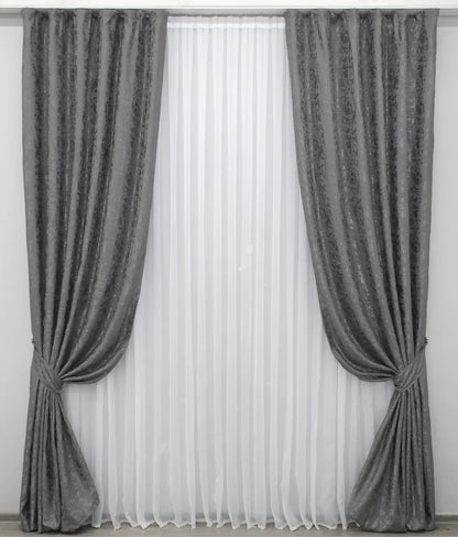 Soft grey linen drapes with a delicate marble texture, perfect for stylish and contemporary home decor.
