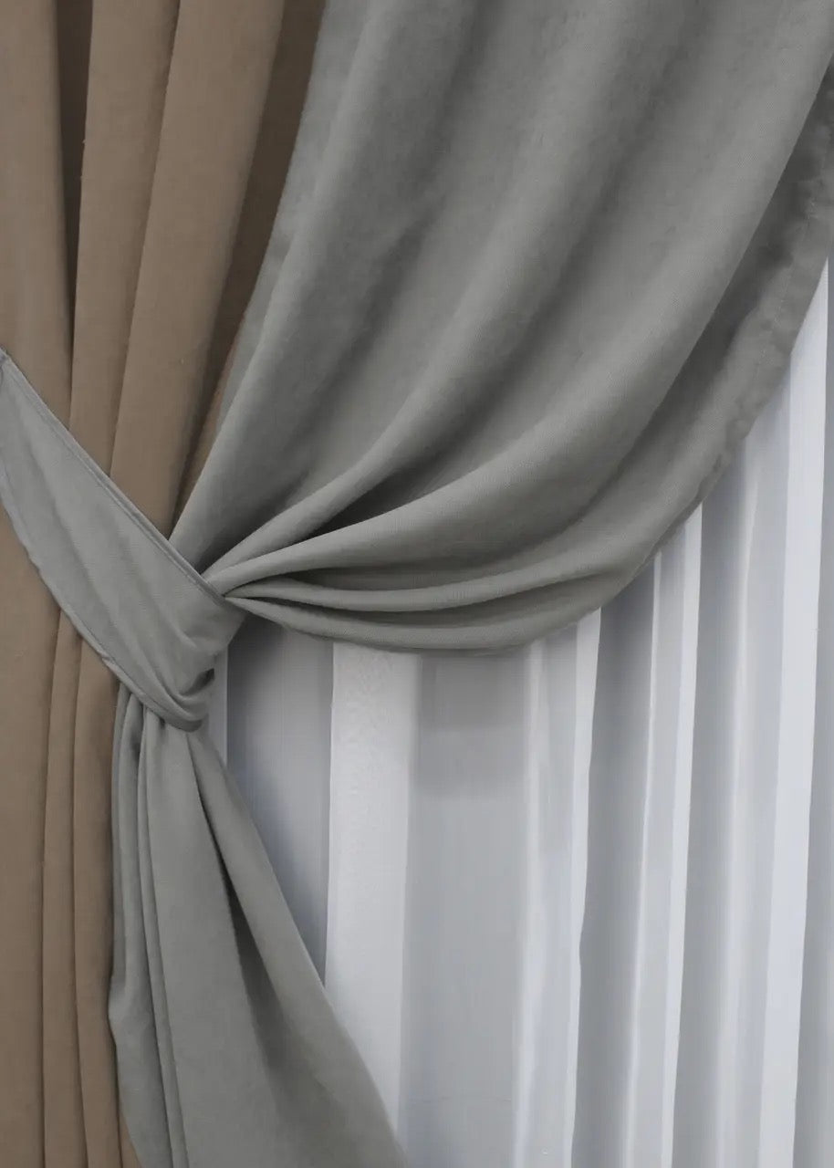 Refined light cocoa and grey microvelvet curtains, perfect for contemporary and minimalist interiors, offering a chic and warm atmosphere.
