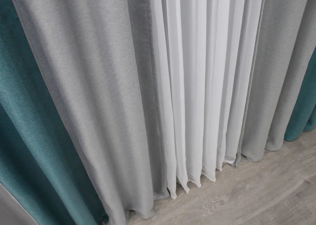 Refined light grey and turquoise linen curtains, seamlessly blending soft neutrals with vibrant turquoise, bringing both style and comfort to your space.
