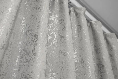 Stylish silver marble-patterned linen drapes, ideal for bright, open, and airy interiors.
