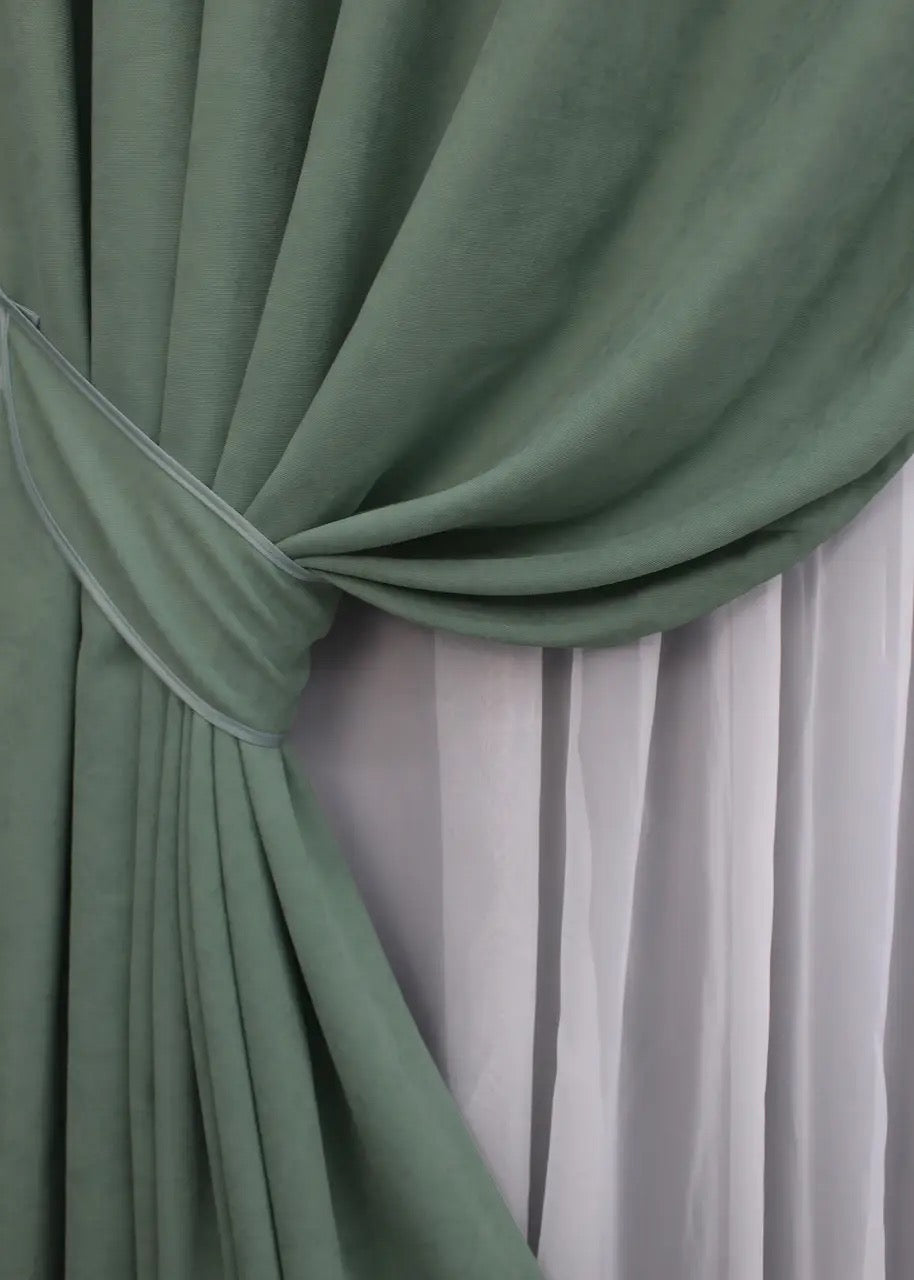 Dark sage green velvet curtains with a sleek design, perfect for minimalist and elegant homes.
