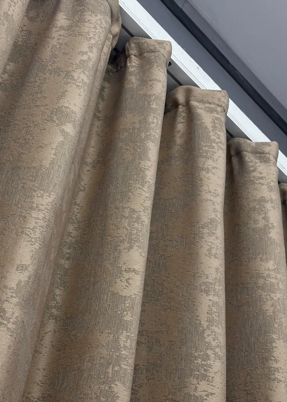 Deep golden-brown curtains with a luxurious finish, creating a cozy and stylish atmosphere in any room.
