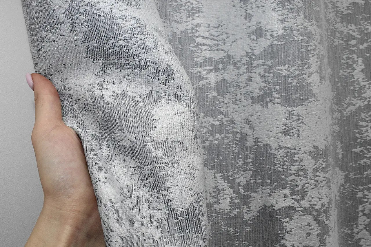 Soft grey jacquard curtains with a delicate woven pattern, enhancing any bedroom or living room.
