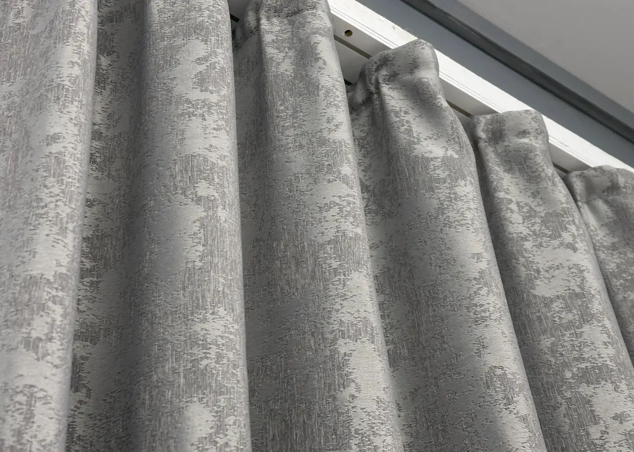 Deep chrome grey curtains with a sleek jacquard pattern, offering a modern yet timeless aesthetic.
