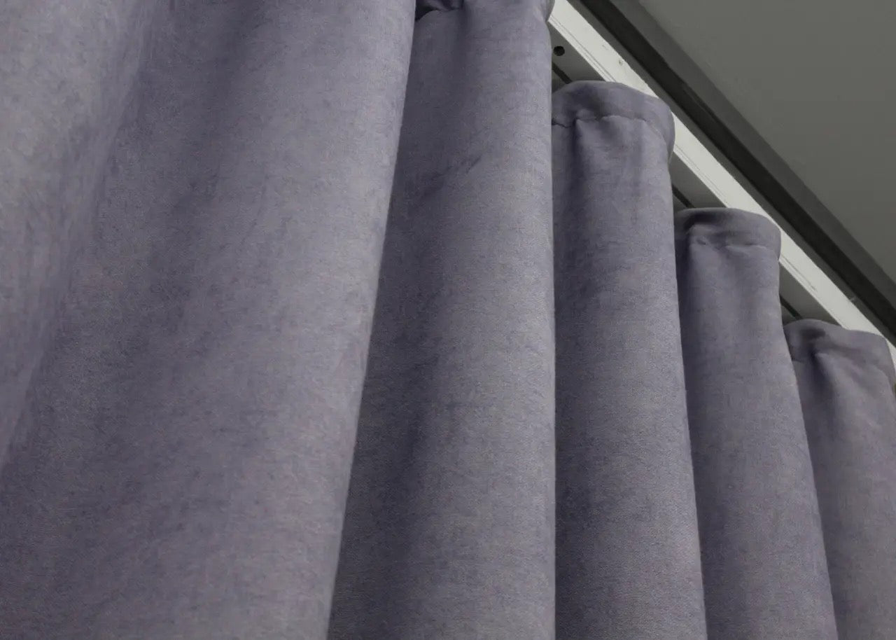 Timeless grayish purple microvelvet curtains, creating a sophisticated and warm interior setting.
