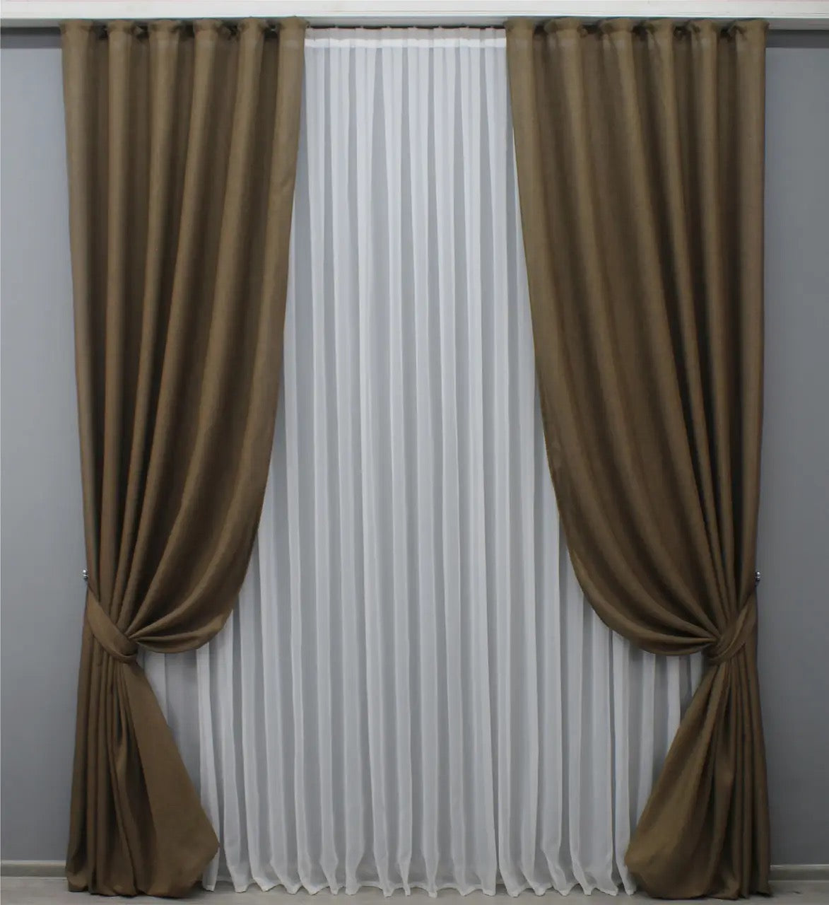 Rustic brown linen curtains on a wooden rod, featured in a Spring Sale promotion for eco-friendly home decor.