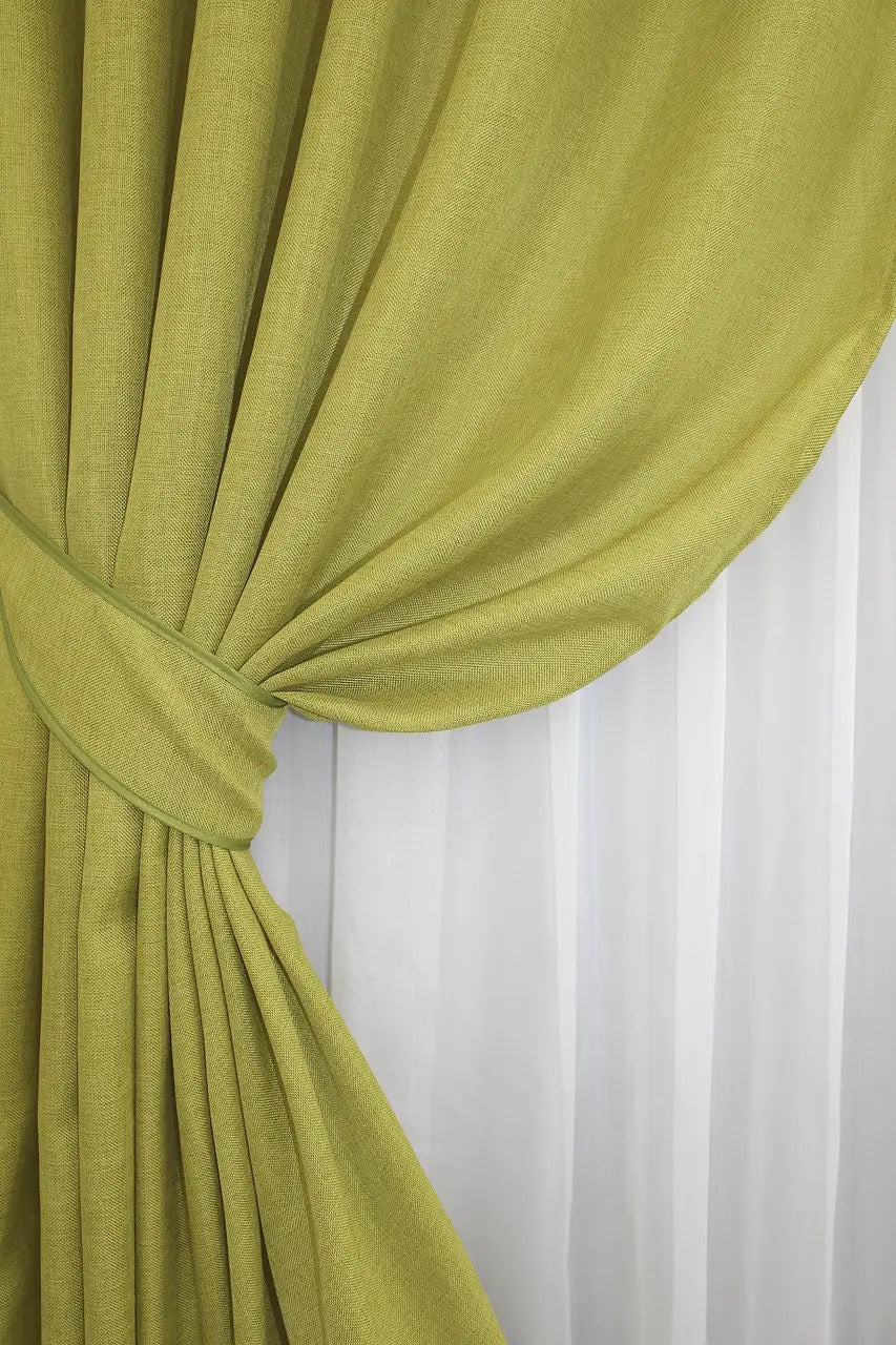 Sage green linen curtains with a textured fabric, perfect for creating a contemporary and inviting home atmosphere.
