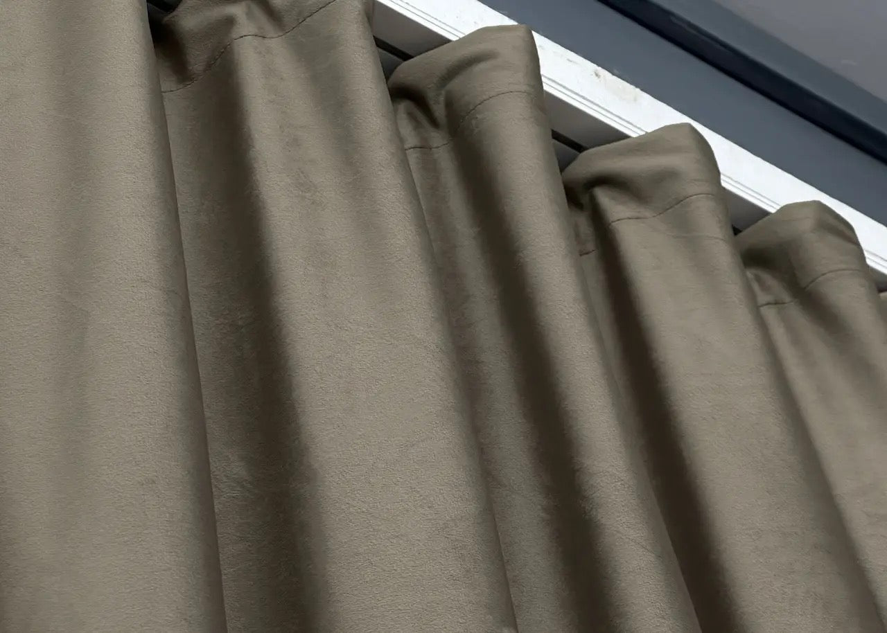 Smoky taupe velvet room darkening curtains, made from high-quality soft fabric to enhance any interior space.
