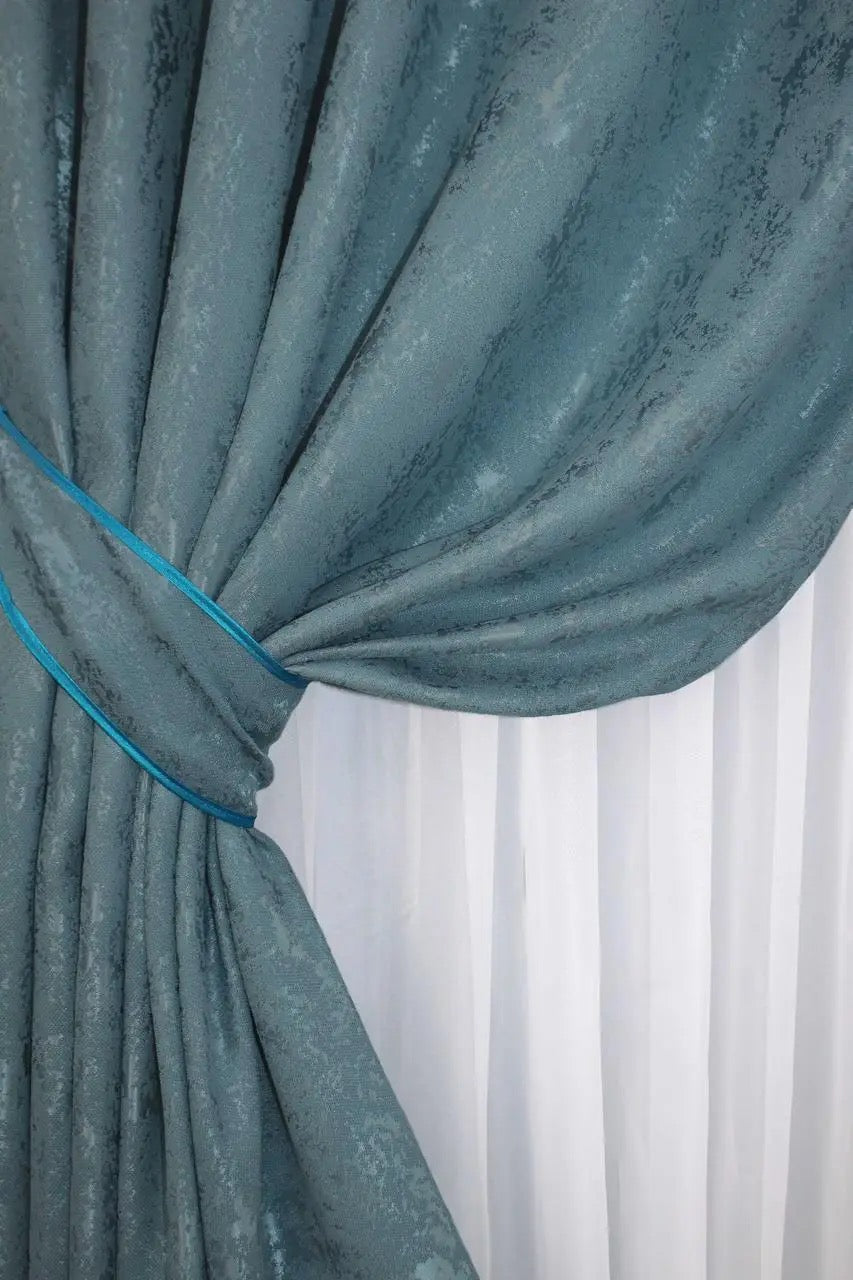 Stylish azure curtains made from breathable linen, providing privacy and soft natural illumination.
