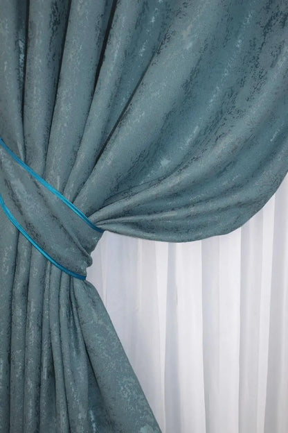 Stylish azure curtains made from breathable linen, providing privacy and soft natural illumination.
