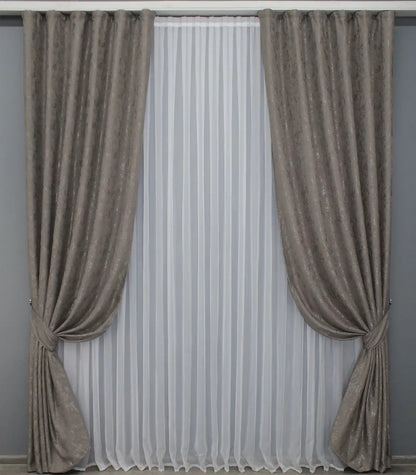 Soft brown-grey linen drapes with a delicate textured fabric, perfect for cosy and stylish interiors.
