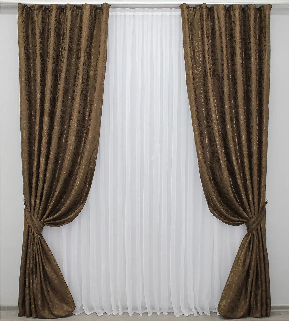 Soft brown linen drapes with a delicate marble texture, perfect for stylish and cosy home decor.

