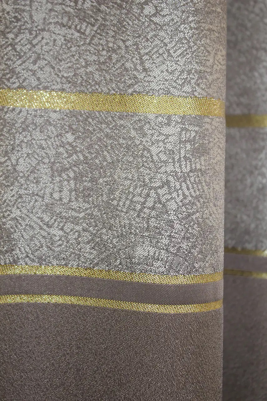 Soft cappuccino linen curtains with subtle gold detailing, perfect for sophisticated bedrooms.
