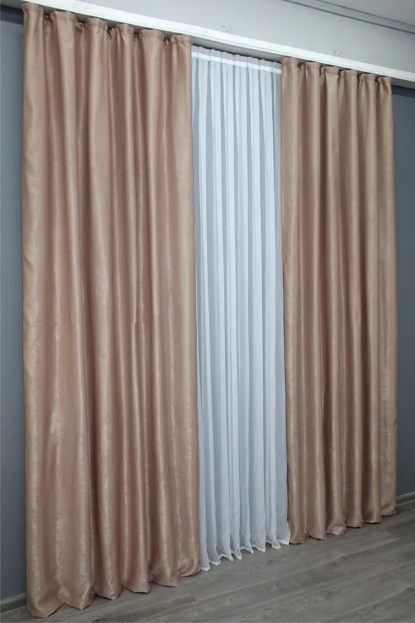 Soft caramel velvet blackout drapes, featuring thick, noise-reducing fabric for peaceful and stylish home spaces.
