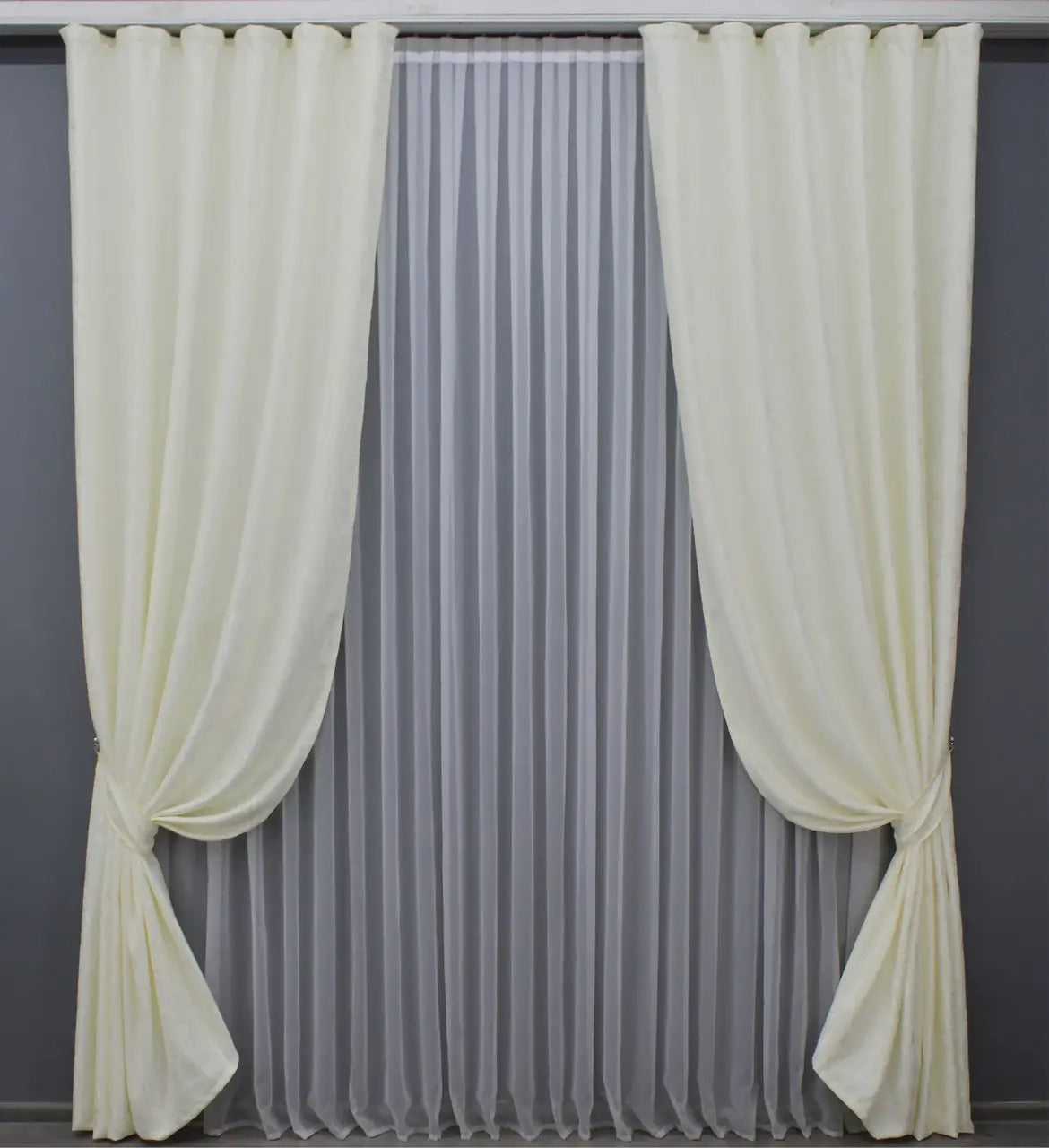 Soft cream linen drapes with a delicate marble texture, perfect for sophisticated and stylish home decor.
