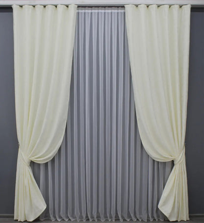 Soft cream linen drapes with a delicate marble texture, perfect for sophisticated and stylish home decor.
