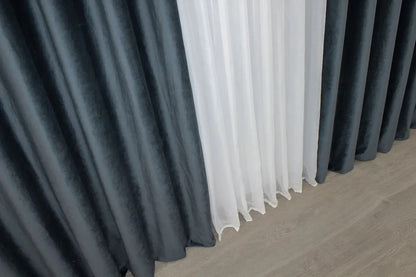 Luxurious dark grey-blue velvet curtains offering 90% light blocking for a calm and comfortable atmosphere in any room.
