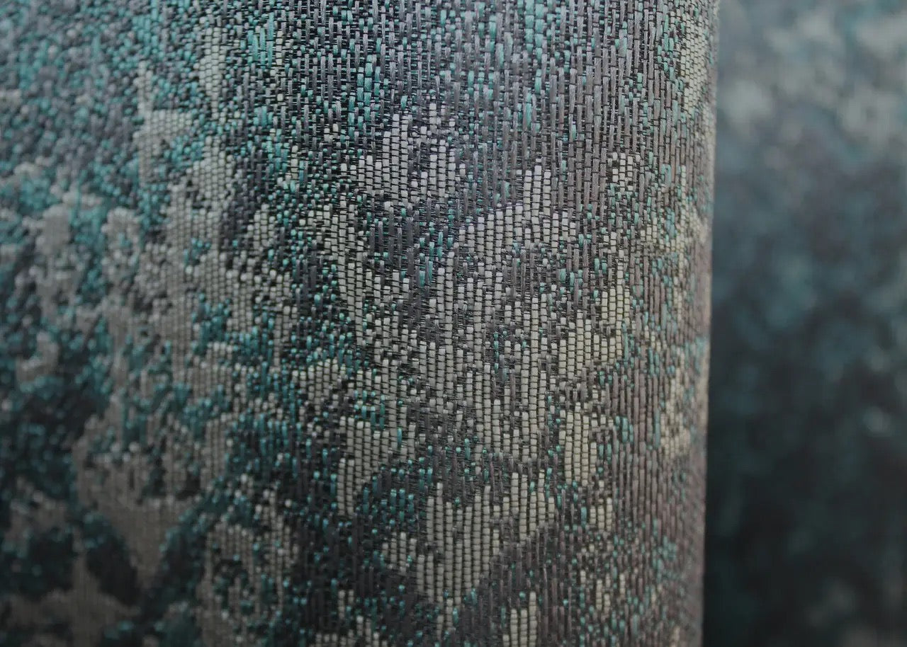 Contemporary teal and grey linen curtains, providing soft light filtering and a sophisticated ambience.
