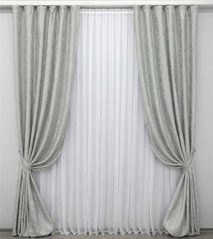 Soft light grey linen drapes with a delicate marble texture, perfect for stylish and contemporary home decor.
