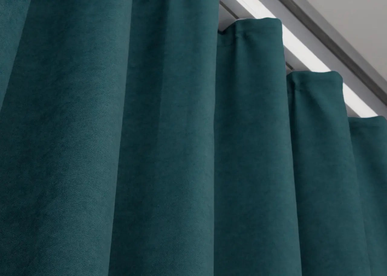 Soft microvelvet curtains in azure blue, featuring a subtle sheen and smooth texture.
