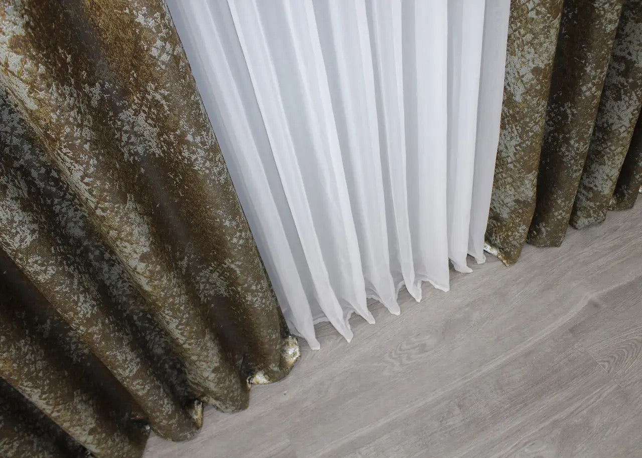 Soft-textured linen curtains with a subtle brown and grey marble pattern, ideal for creating a cosy ambience.
