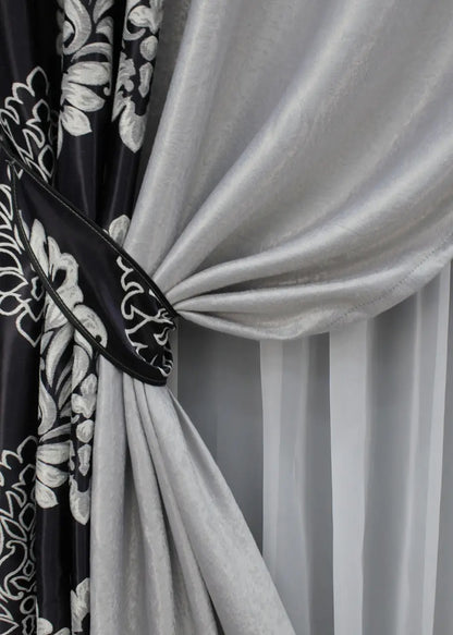 Modern black and light grey blackout curtains, offering a refined, balanced aesthetic and excellent light reduction.
