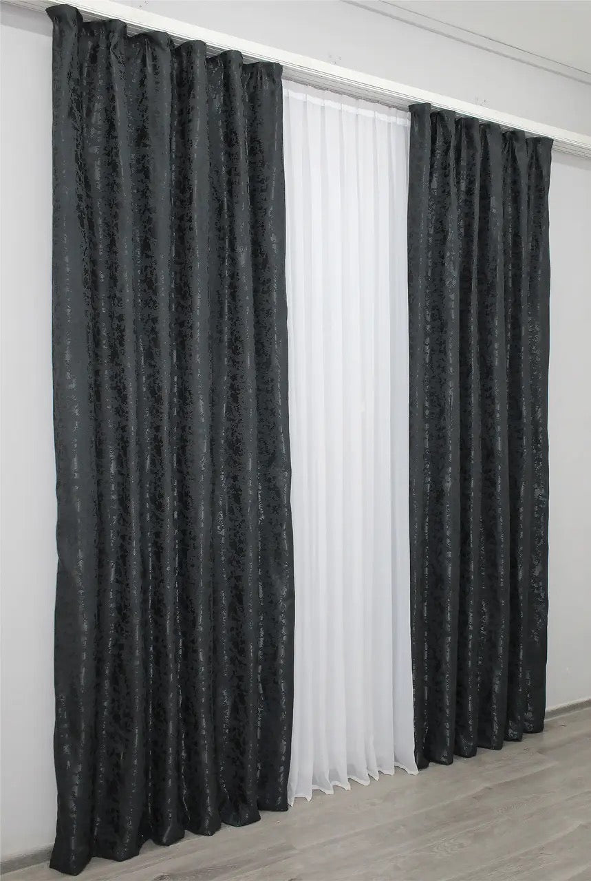 Light-filtering blue-graphite linen curtains with a soft finish, creating a sleek and stylish atmosphere.
