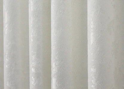 Timeless cream linen drapes with a subtle marble pattern, perfect for bright, minimalist interiors.
