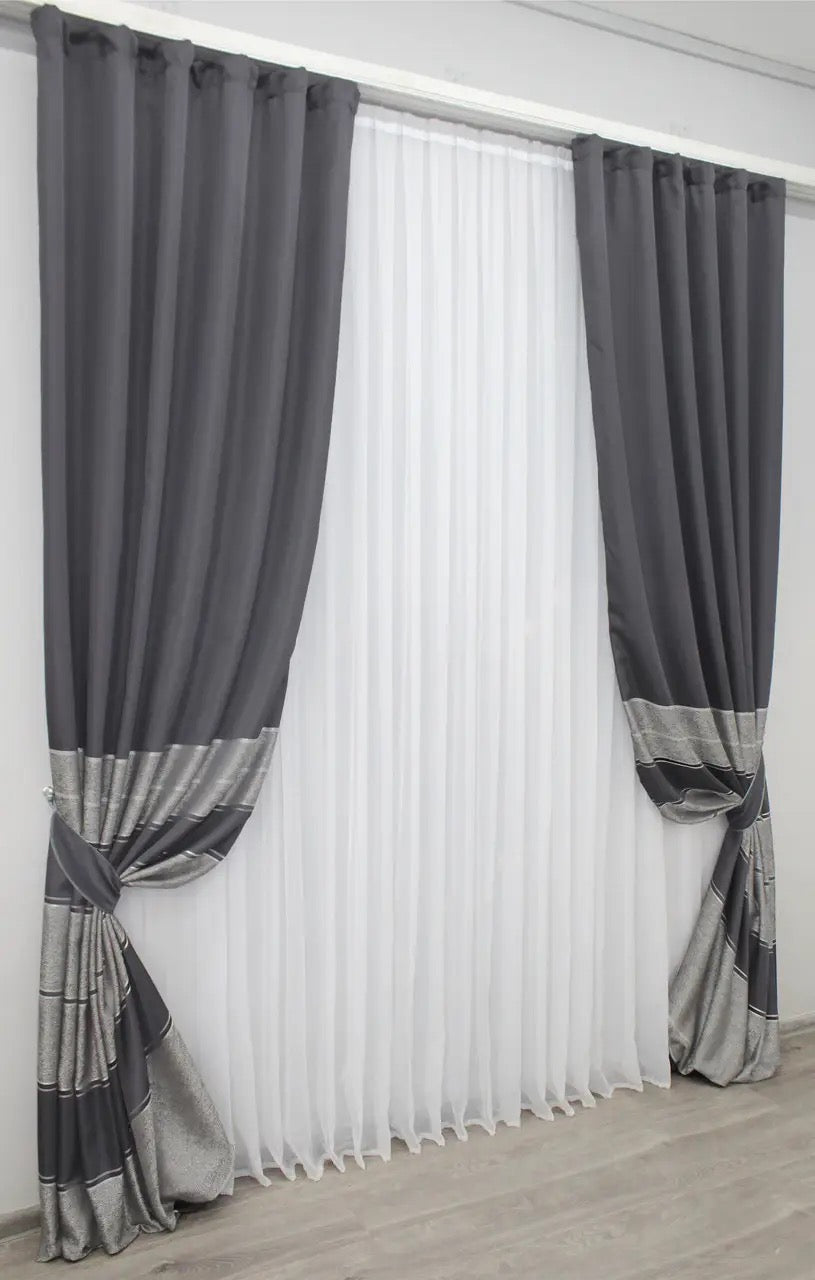 Sophisticated charcoal grey curtains with refined silver detailing, ideal for stylish living rooms.
