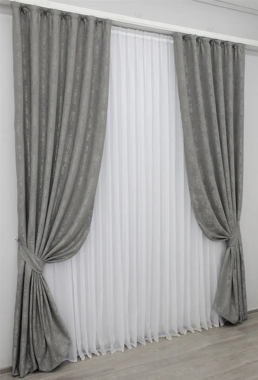 Stylish grey jacquard curtains offering a subtle yet refined tone, ideal for both contemporary and classic interiors.
