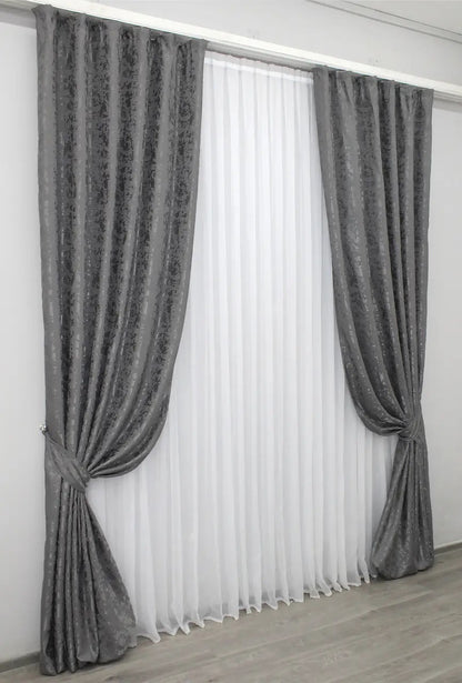 Light-filtering grey linen curtains with a soft finish, creating a sleek and stylish atmosphere.
