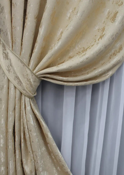 Natural linen curtains in beige with a delicate marble texture, complementing neutral home decor.
