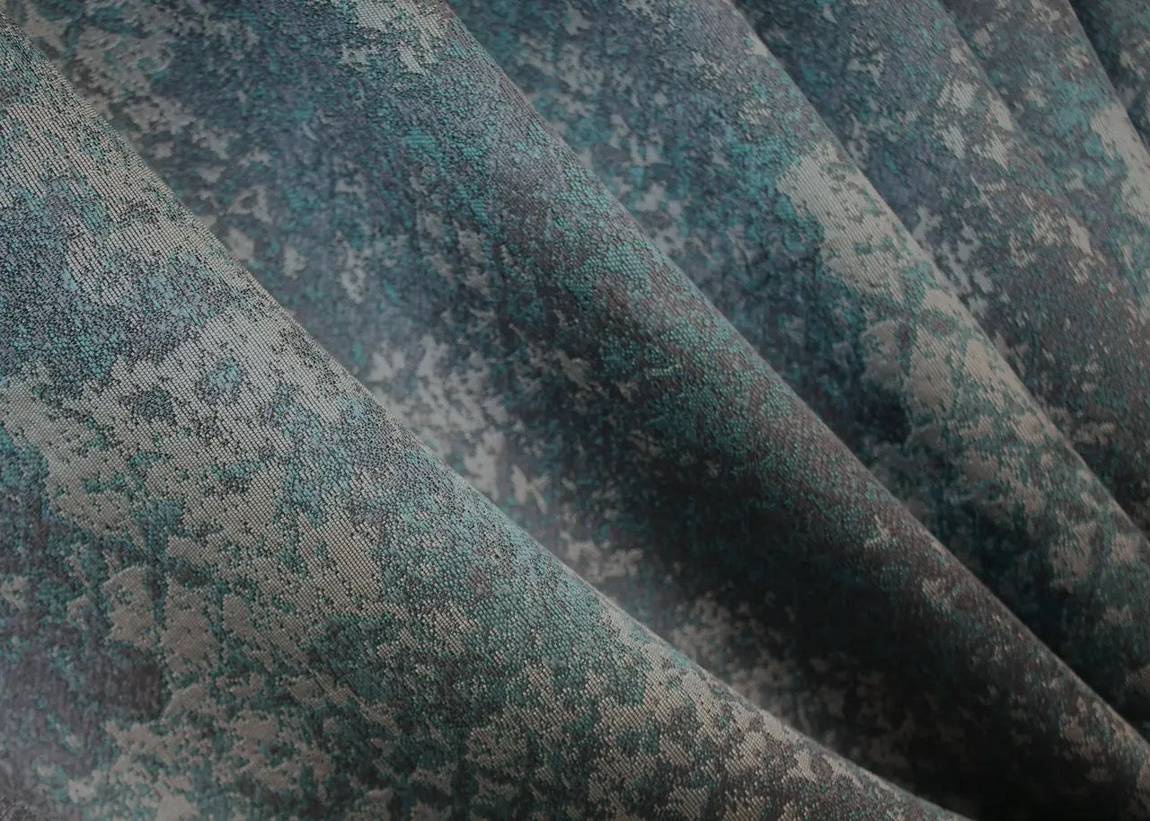 Light-filtering deep teal and grey linen curtains with a subtle marble design for a chic interior.
