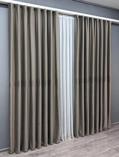 Stone grey velvet curtains with a timeless design, crafted for bedroom and living room décor, adding sophistication and warmth.
