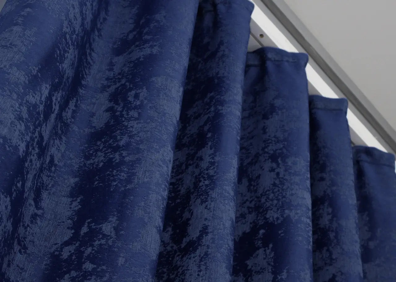 Classic blue curtains with a detailed jacquard pattern, blending seamlessly into modern and elegant décor.
